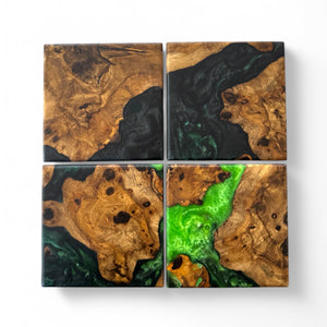 Maple burl coasters with a swirling green resin with a white background.