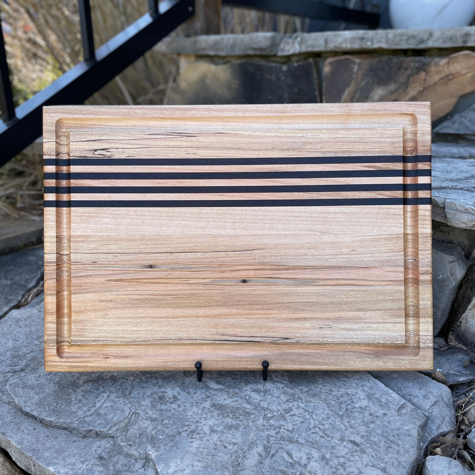 Figured maple cutting board with wenge wood inlays.