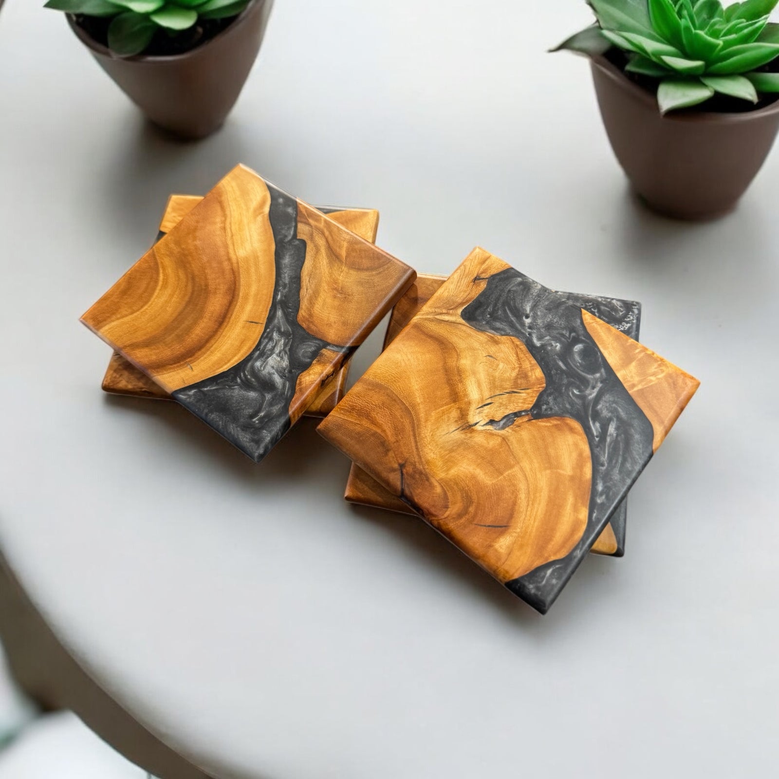 Maple Burl Coasters with Silver Resin sitting on a coffee table.