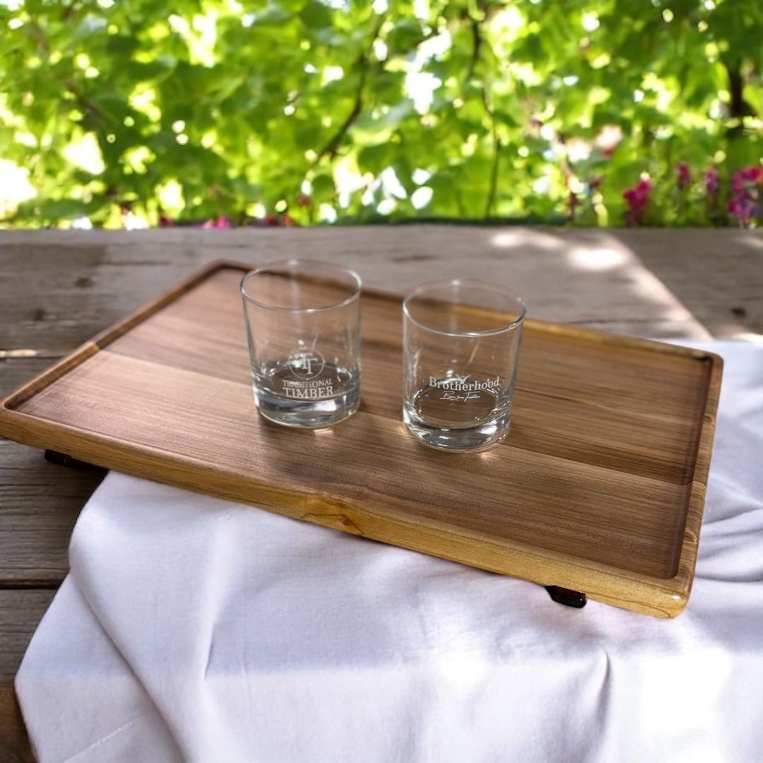 Maple wood serving tray with walnut inlayed feet. On the tray are 2 glasses.