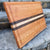 A side view of a cherry cutting board, you can see the juice groove and the finger grooves.