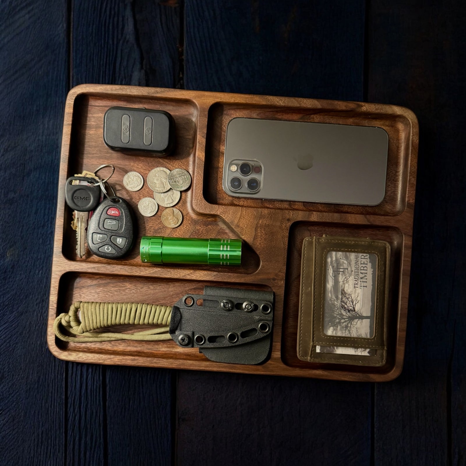 A walnut catch all tray that can hold a cellphone, keys, wallet and anything else you can carry on a daily basis.