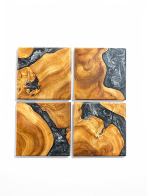 Maple burl coasters with silver resin with a white background.