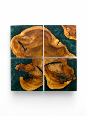 Maple burl coasters with emerald resin with a white background.