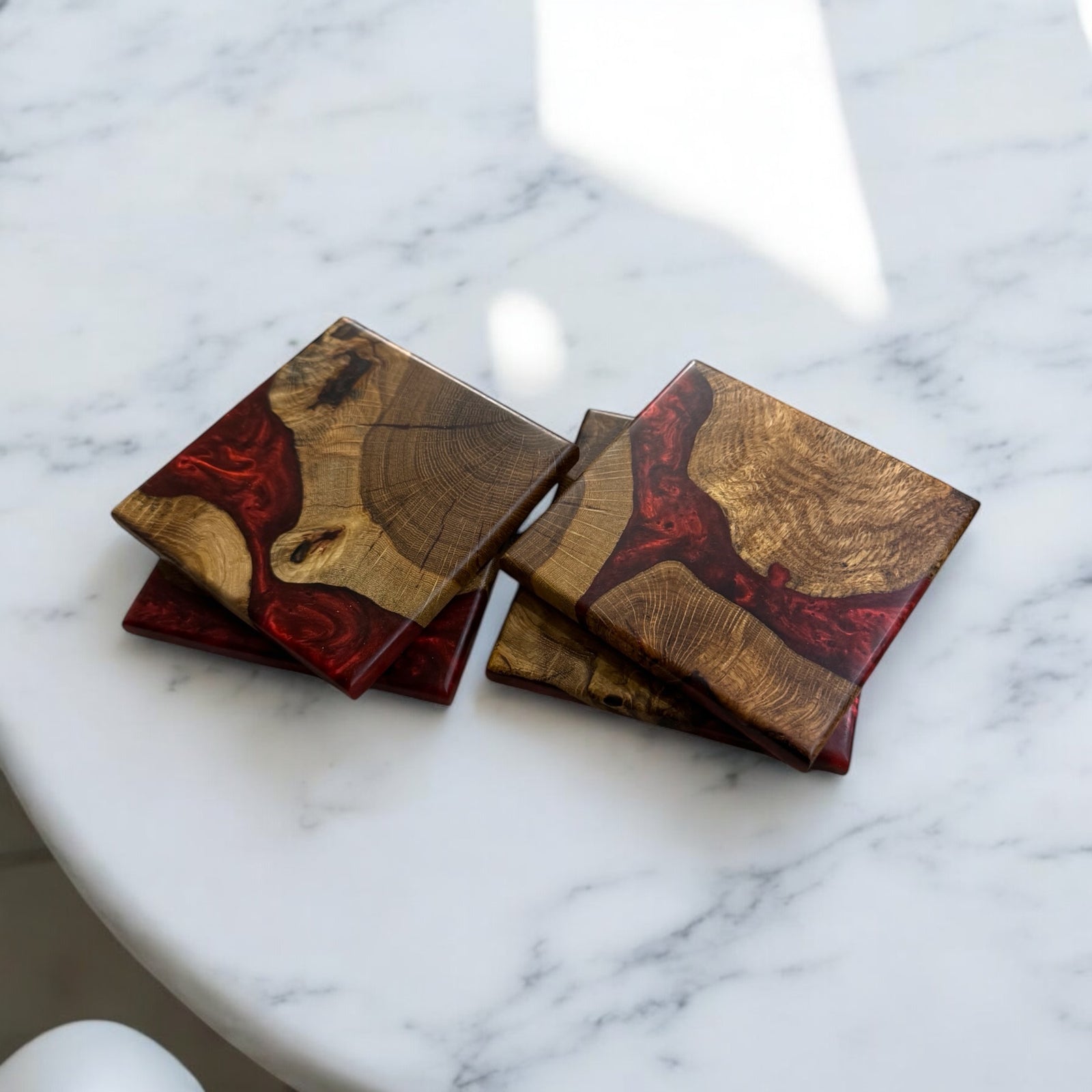 Oak Burl Coasters with Dragon Resin sitting on a Marble Table.