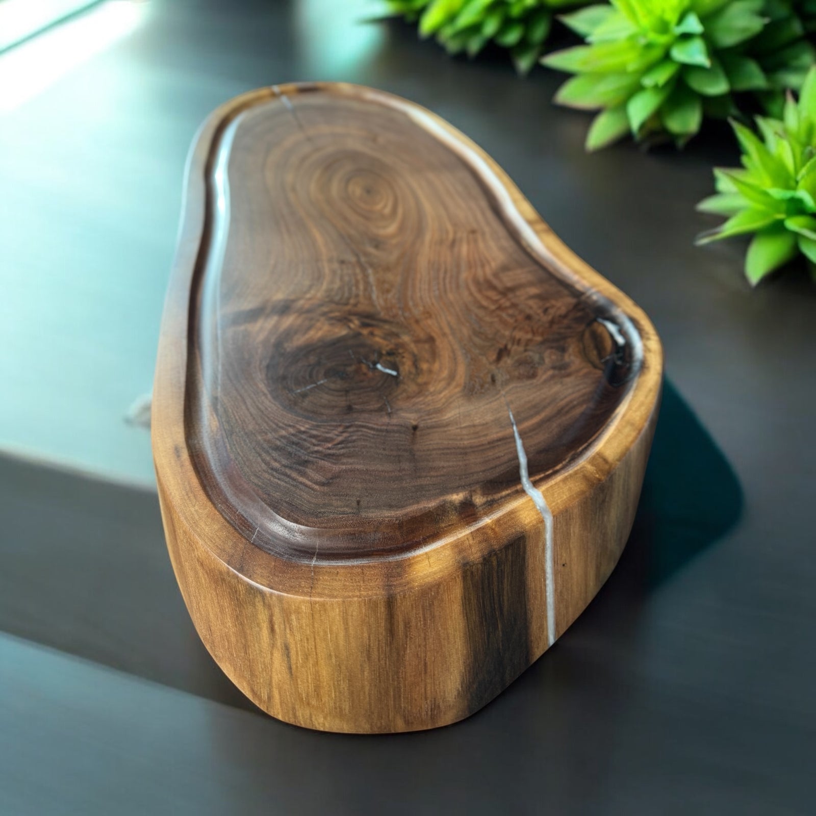 Live Edge Walnut Cutting Board sitting on a dark gray countertop.